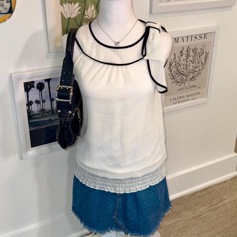 Elegant White Sleeveless Top with Black Trim